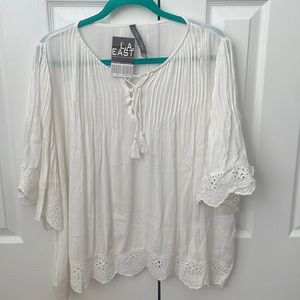 Flowing cream white top.